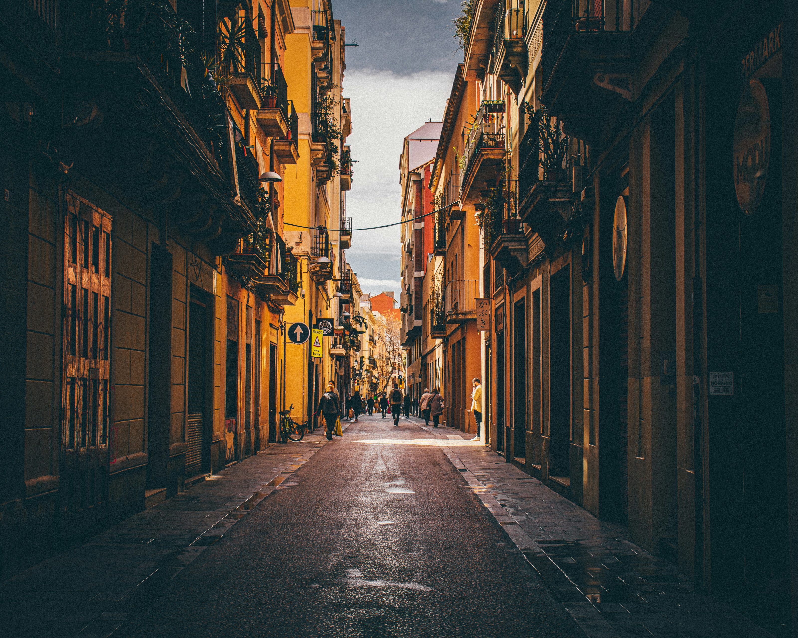 A narrow street in Barcelona's old town at golden hour